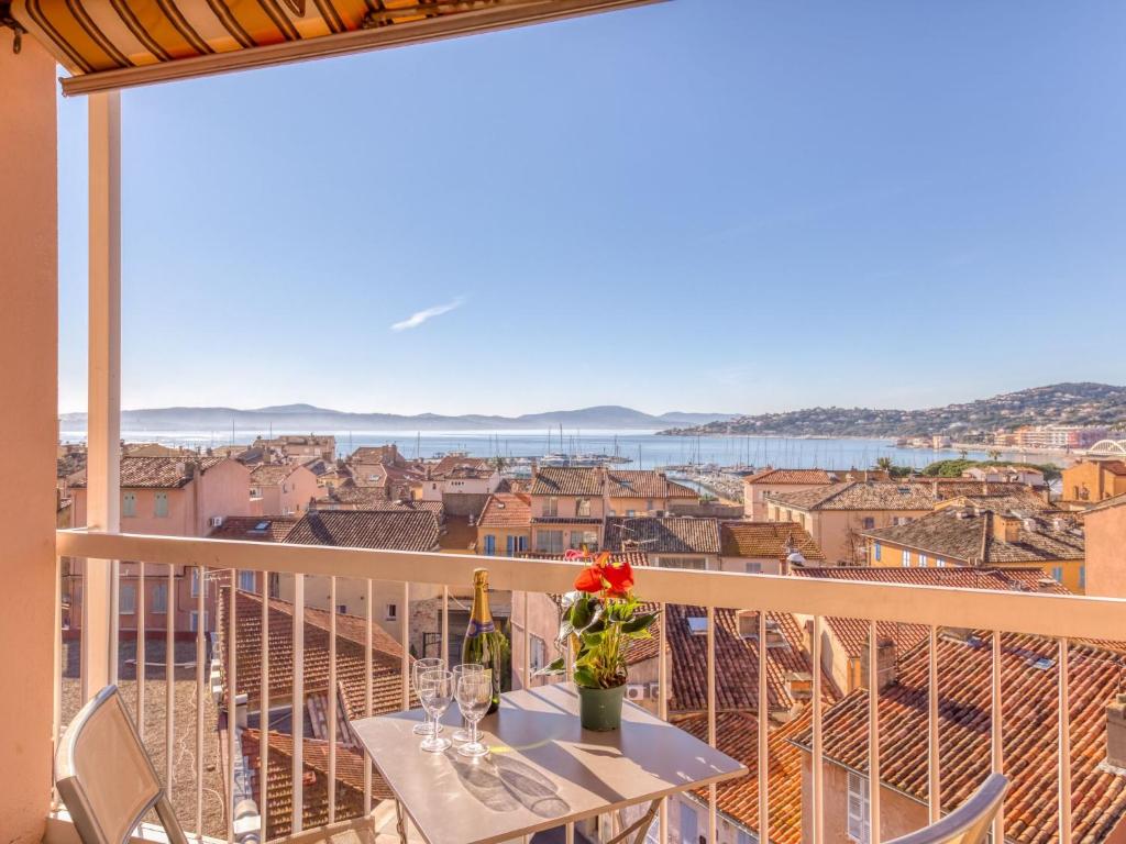 a balcony with a table and a view of the city at Apartment Les Pins Dorés-2 by Interhome in Sainte-Maxime