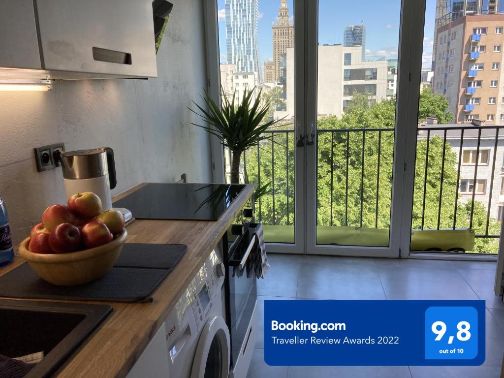 a kitchen with a bowl of fruit on a counter at CENTRUM PANORAMA STUDIO Złota 81 Street Warsaw by Gi4 in Warsaw