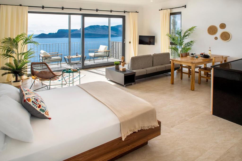 a bedroom with a bed and a living room at Born in Blue in Kaş