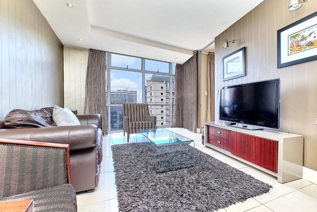 a living room with a flat screen tv and a couch at Comfort Apartment SA in Johannesburg