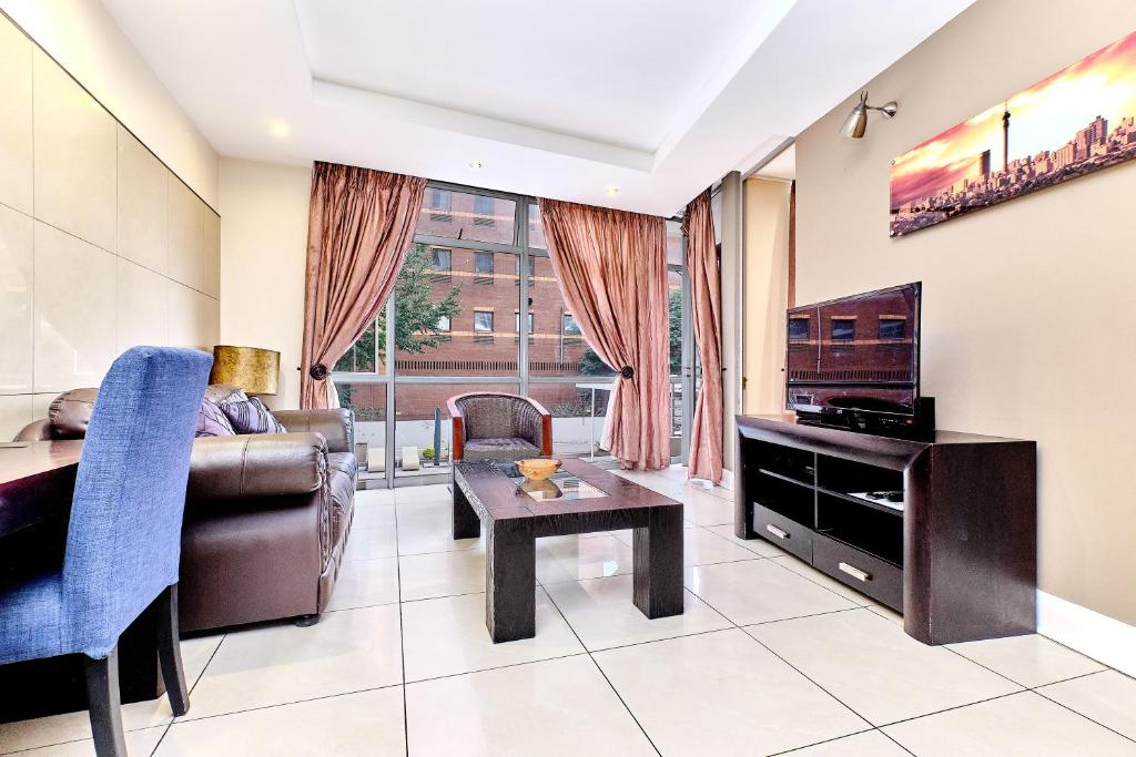 a living room with a couch and a table at Comfort Apartment SA in Johannesburg