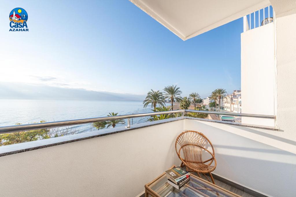 a balcony with a chair and a view of the ocean at Apartamentos Vista Alegre Casa Azahar in Alcossebre