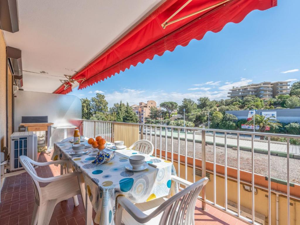 a dining room with a table and chairs on a balcony at Apartment Le Suzy by Interhome in Cavalaire-sur-Mer