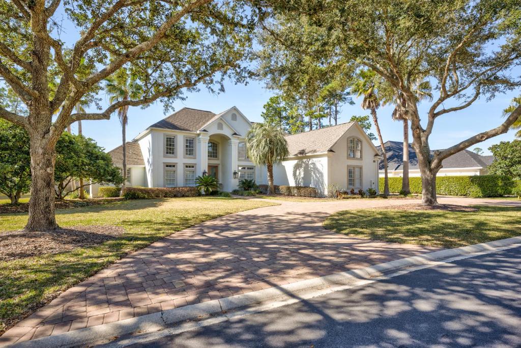 a white house with trees and a driveway at Players Choice in Ponte Vedra
