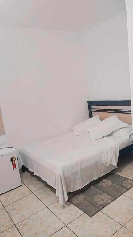 Cama ou camas em um quarto em Pousada Aquarela