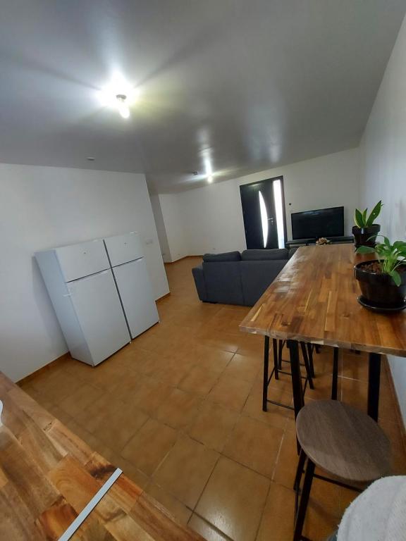 a living room with a table and a couch at K&N - Maison à partager avec d'autres voyageurs - Chambre privée - Jardin - Balcon in Vaulx-en-Velin