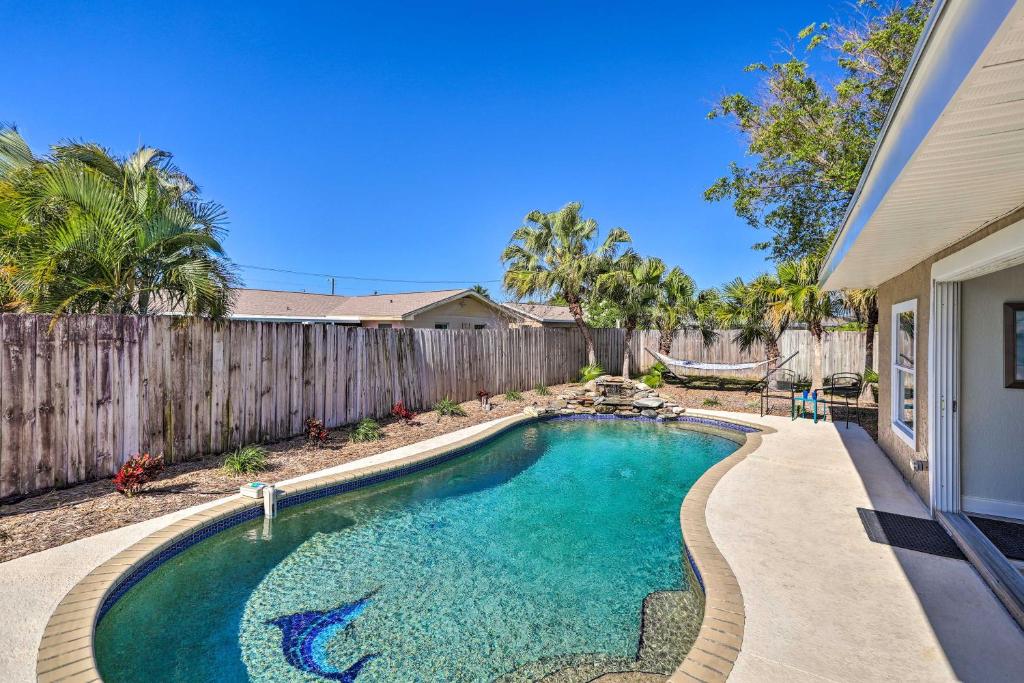 a swimming pool in the backyard of a house at Merritt Island Home - Family and Pet Friendly! in Merritt Island