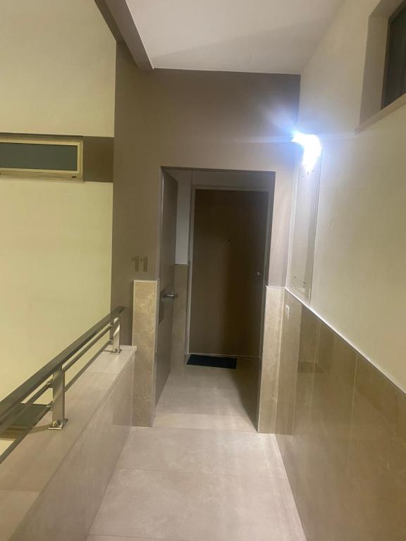 a hallway in a building with a dark door at Urban Chic Home in Bari