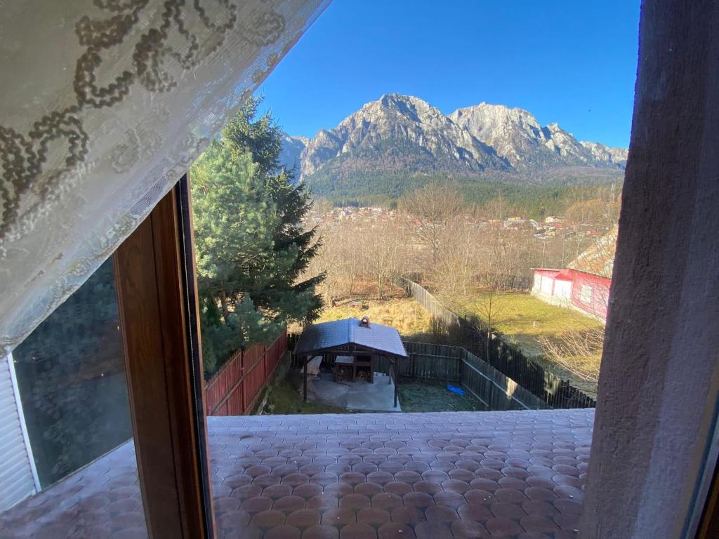 a window with a view of a mountain at B House Bușteni in Buşteni