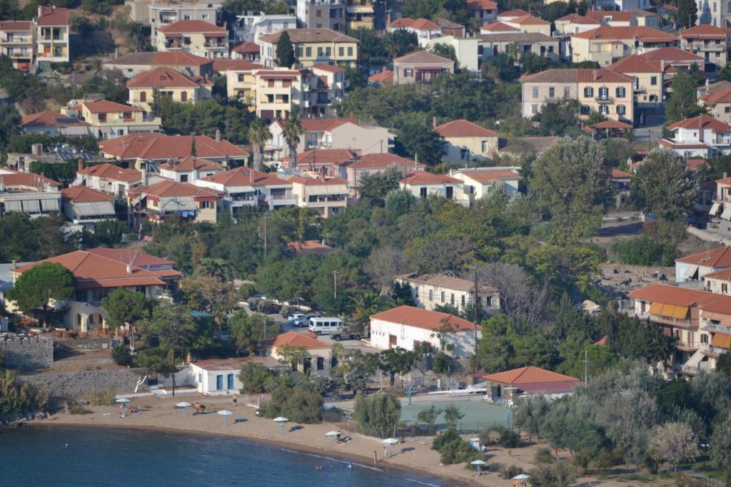 a town on a hill with houses and a beach at Artemis Traditional Hotel in Myrina
