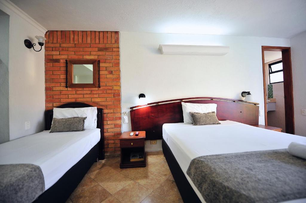 Postel nebo postele na pokoji v ubytování Hotel Cabo de la Vela Medellin