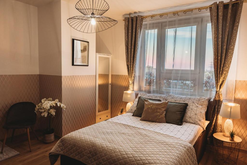 a bedroom with a bed and a large window at ClickTheFlat Gdański Center Prestige Apart Rooms in Warsaw