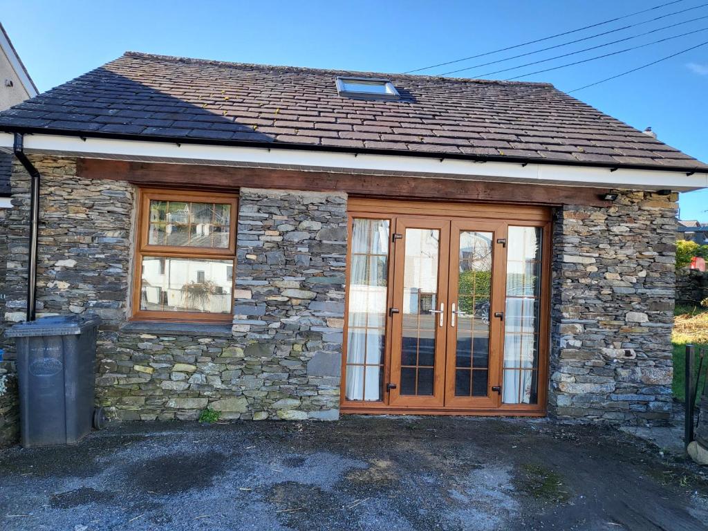 a small stone house with a wooden door at The Annexe in Ulverston