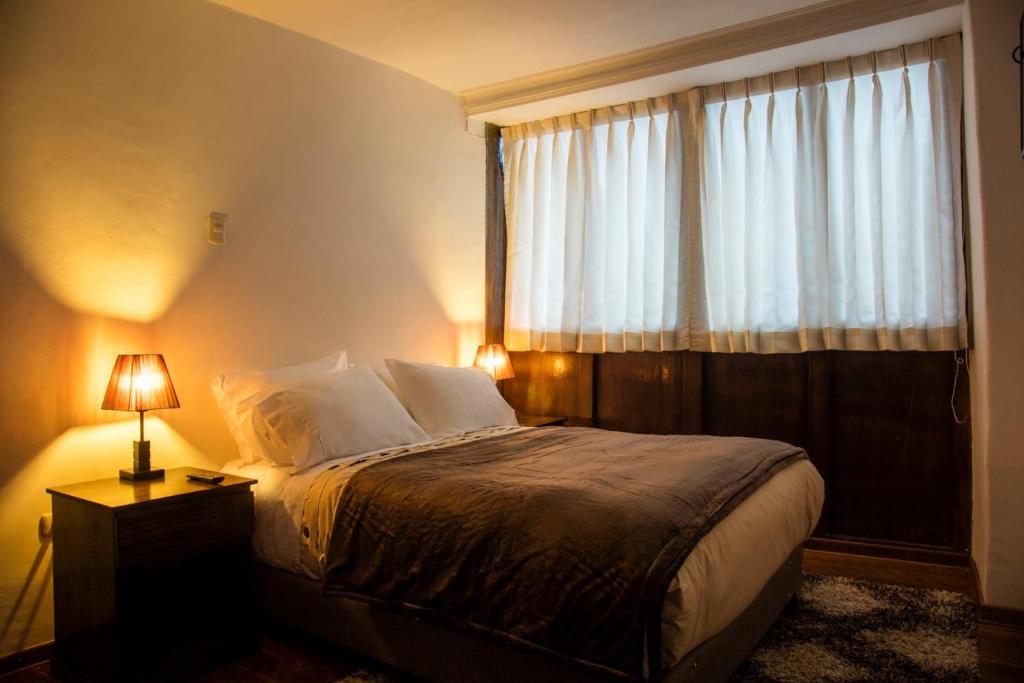 Postel nebo postele na pokoji v ubytování Hotel Casa Fierro Cusco