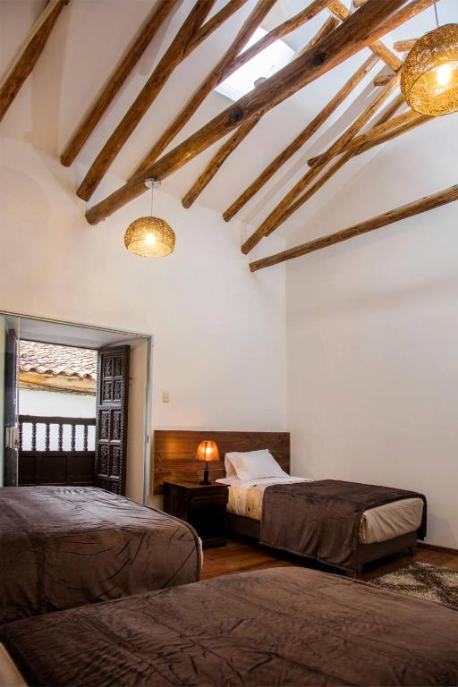 Postel nebo postele na pokoji v ubytování Hotel Casa Fierro Cusco