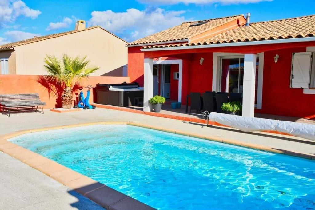 a swimming pool in front of a house at Villa de 3 chambres avec piscine privee jacuzzi et jardin clos a Carcassonne in Carcassonne