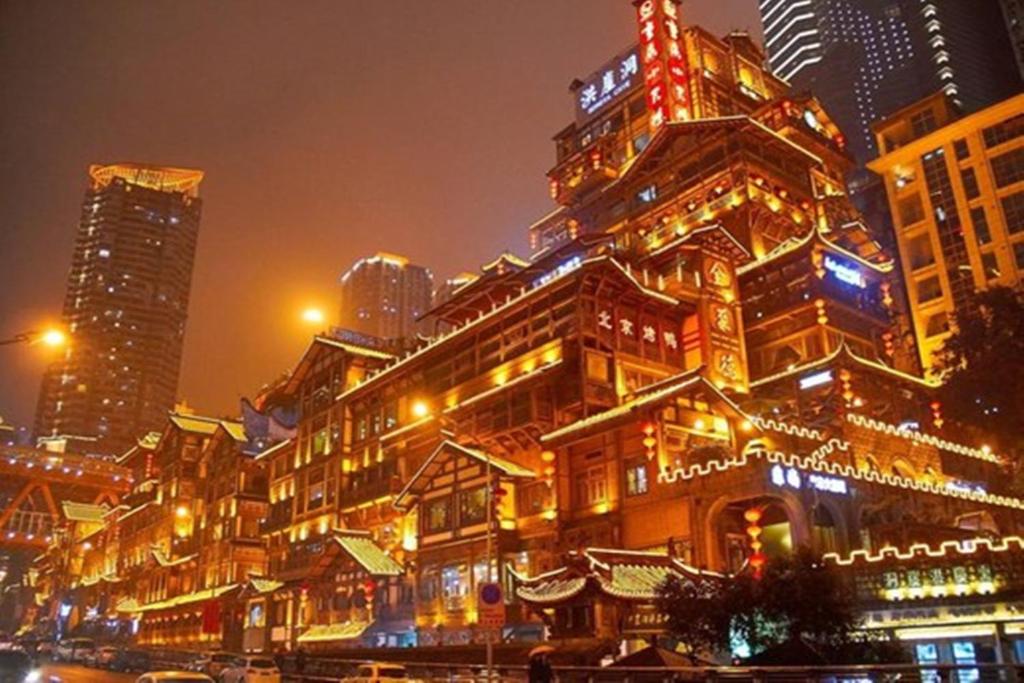 a building with christmas lights on it in a city at Chongqing Yuzhong District · Hongyadong in Chongqing