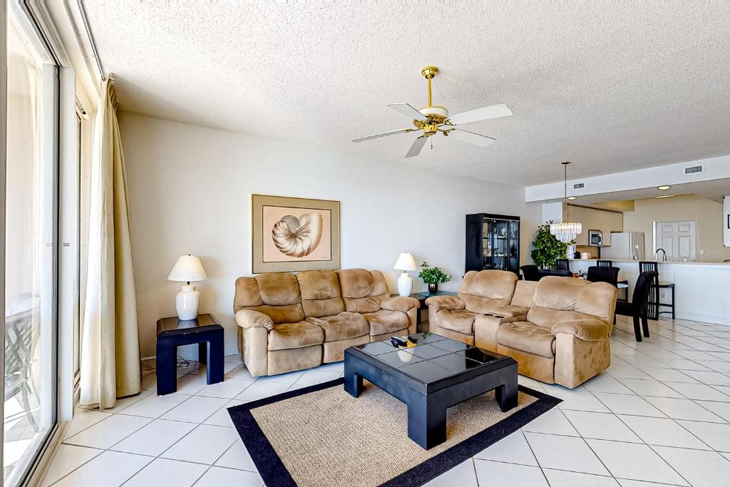 a living room with two couches and a table at Navarre Beach Regency 308 in Navarre