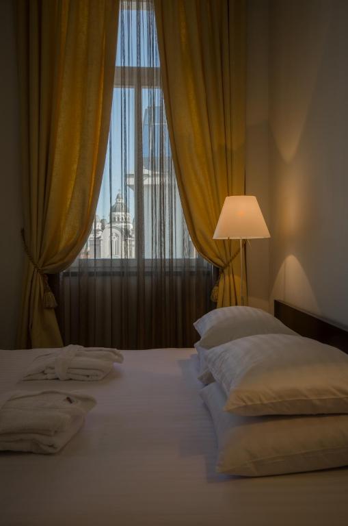 Postel nebo postele na pokoji v ubytování Hotel Concordia
