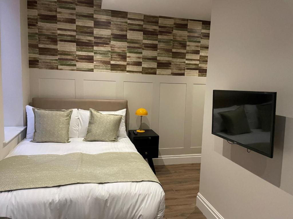 Postel nebo postele na pokoji v ubytování The Gresham Aparthotel