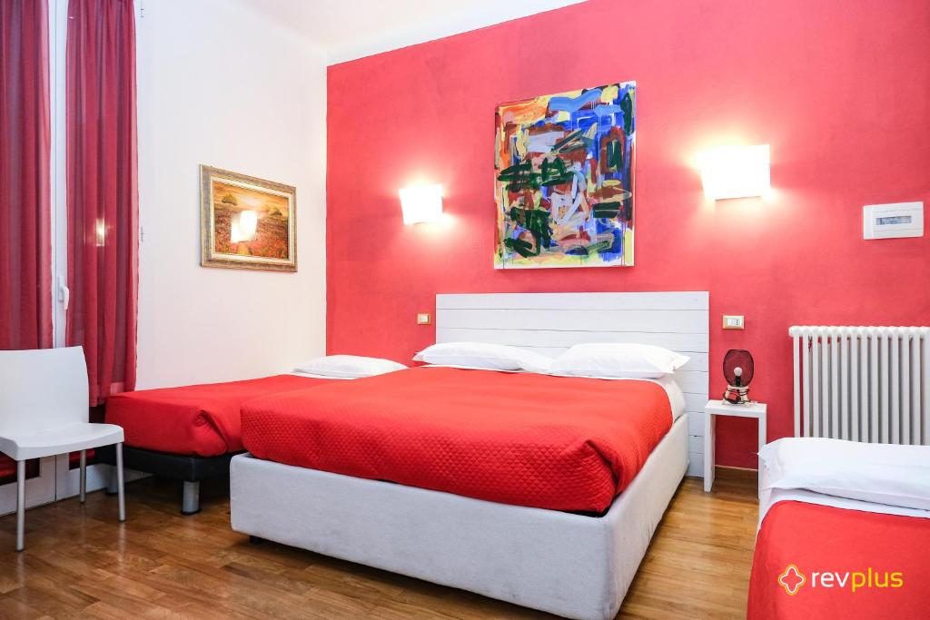 een rode slaapkamer met een bed en een rode muur bij Lia Rooms in La Spezia