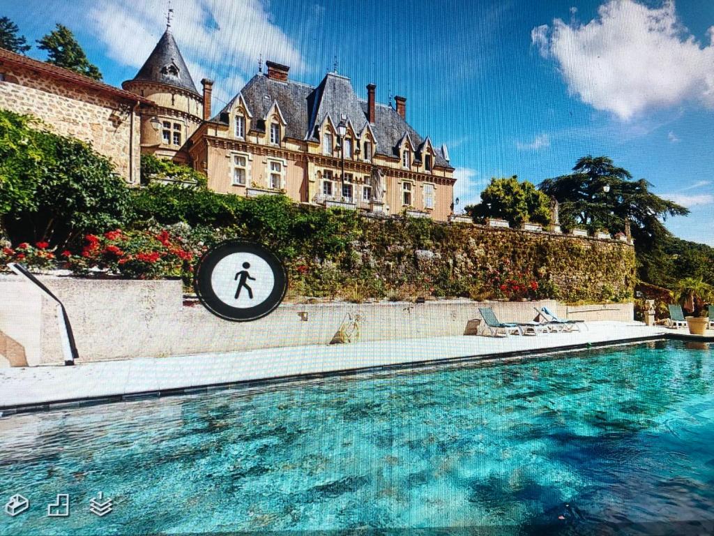 a swimming pool in front of a large building at Chateau d'Urbilhac in Lamastre