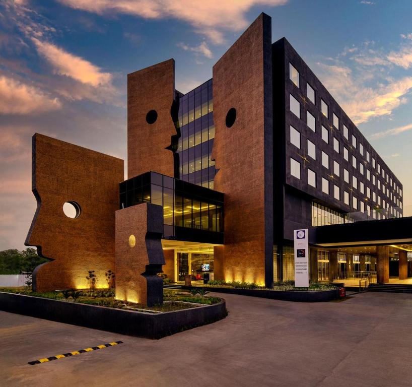 a large brick building with a building at Essentia Luxury Hotel Indore in Indore