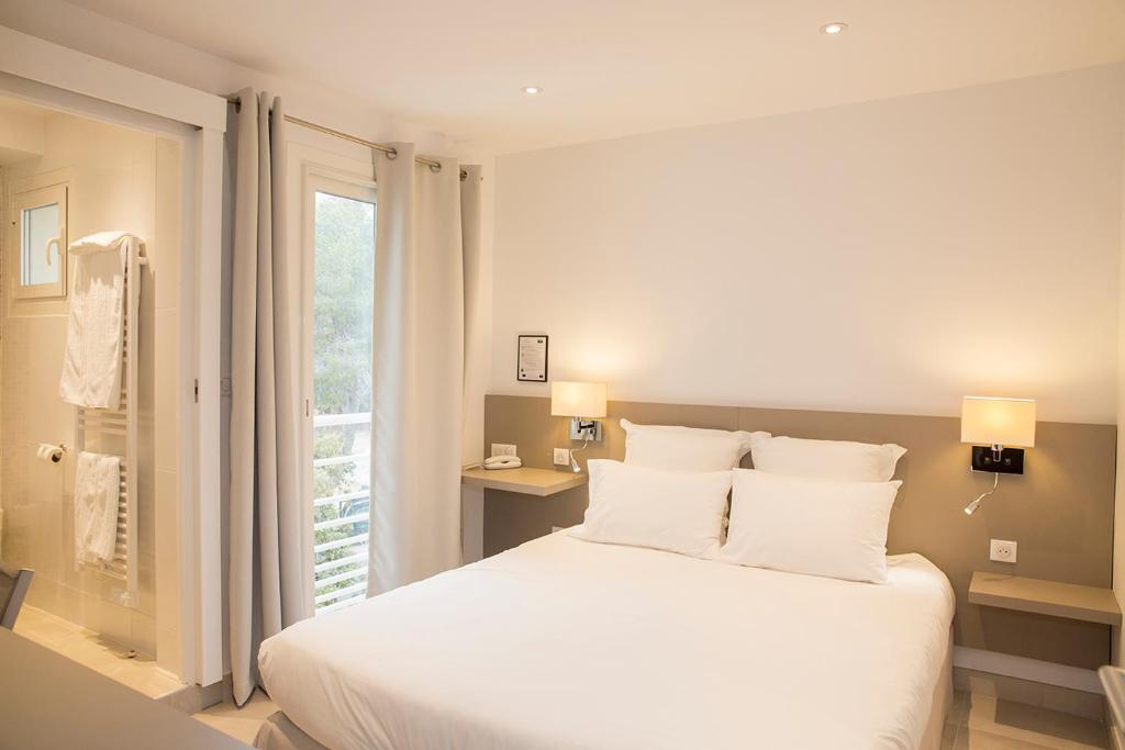 Postel nebo postele na pokoji v ubytování Hôtel de la Plage - HDLP
