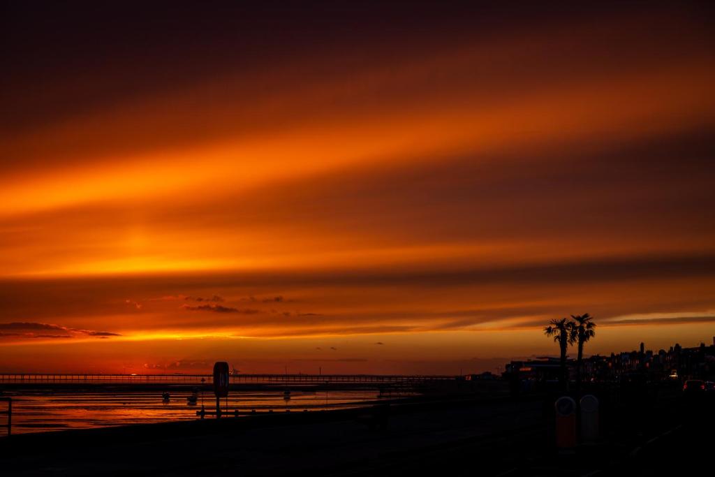 a sunset on the beach with a sky at Roslin Beach Hotel in Southend-on-Sea