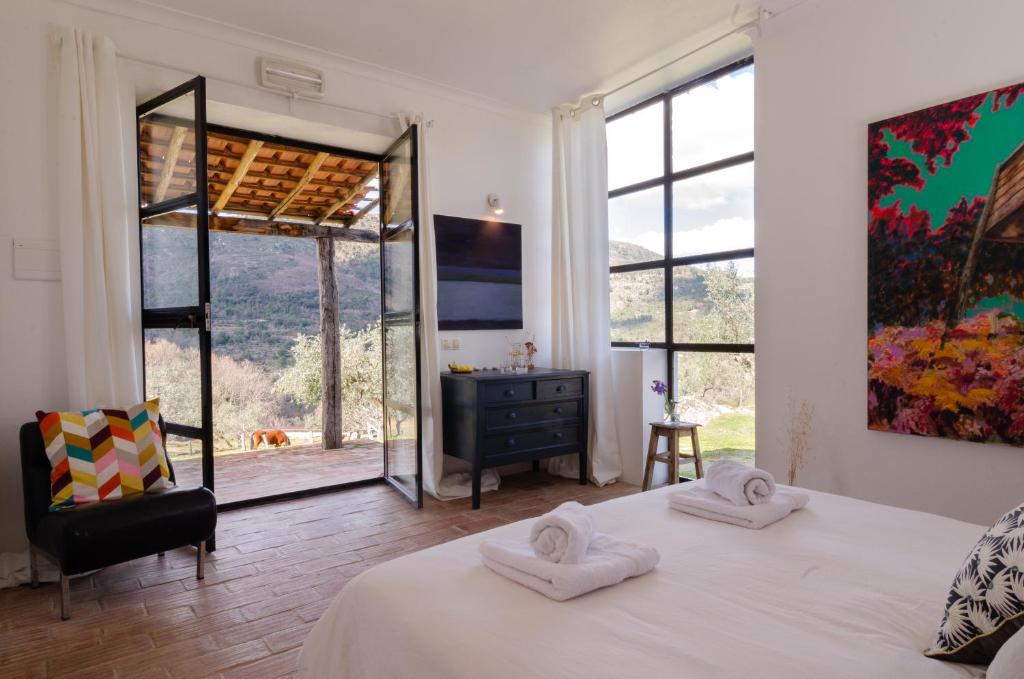 a bedroom with a bed with towels on top of it at Special Farmstay, Faia-Guarda in Faia