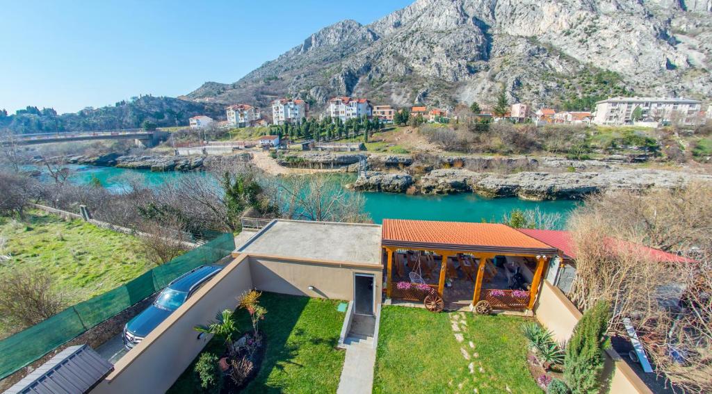 an aerial view of a house with a mountain in the background at Mila Apartments in Mostar
