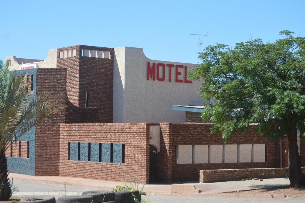 a brick building with a motel sign on it at Postmasburg Inn in Postmasburg