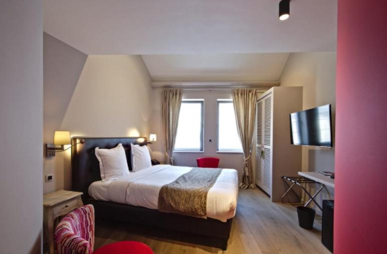 Postel nebo postele na pokoji v ubytování Hotel Saint-Amour