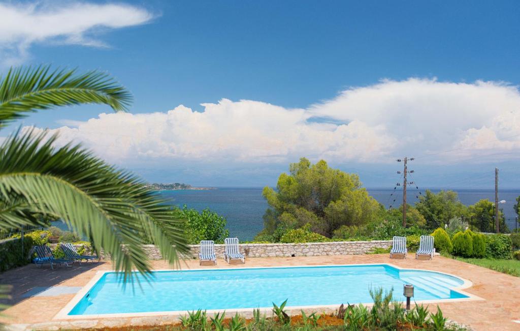 a swimming pool with a view of the water at Akritas in Koroni