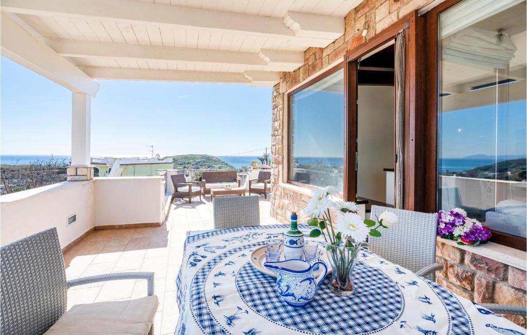 a table on the balcony of a house at Cozy Home In Forio na With House Sea View in Ischia
