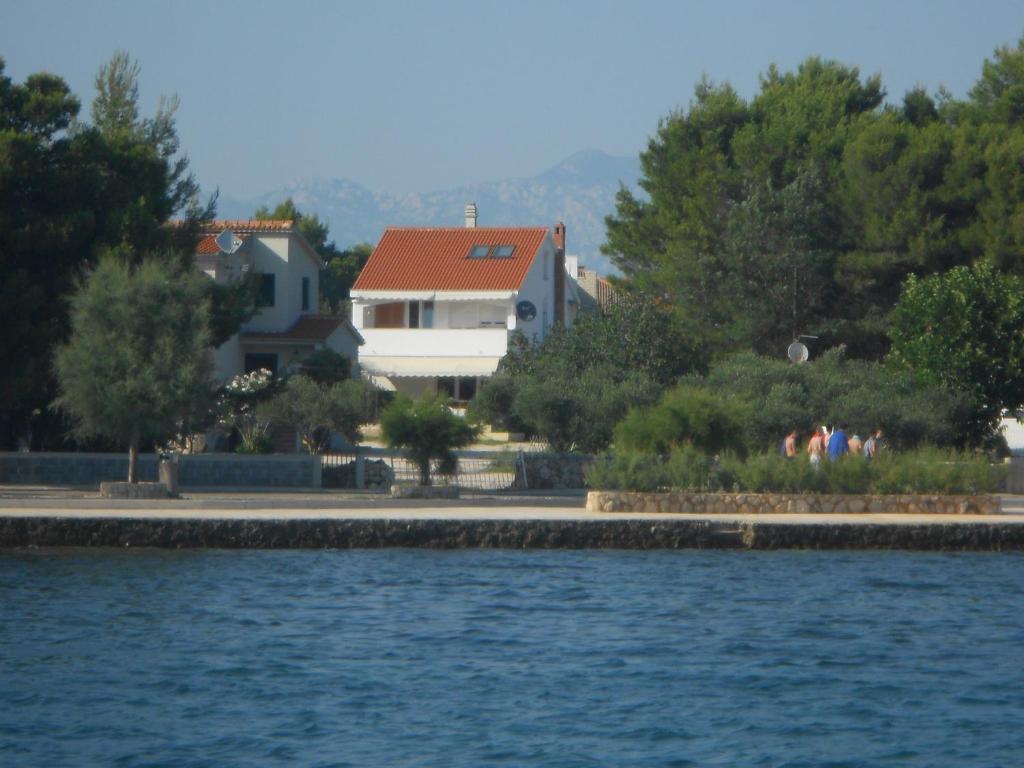 a house next to a body of water at Apartment Niko in Vir