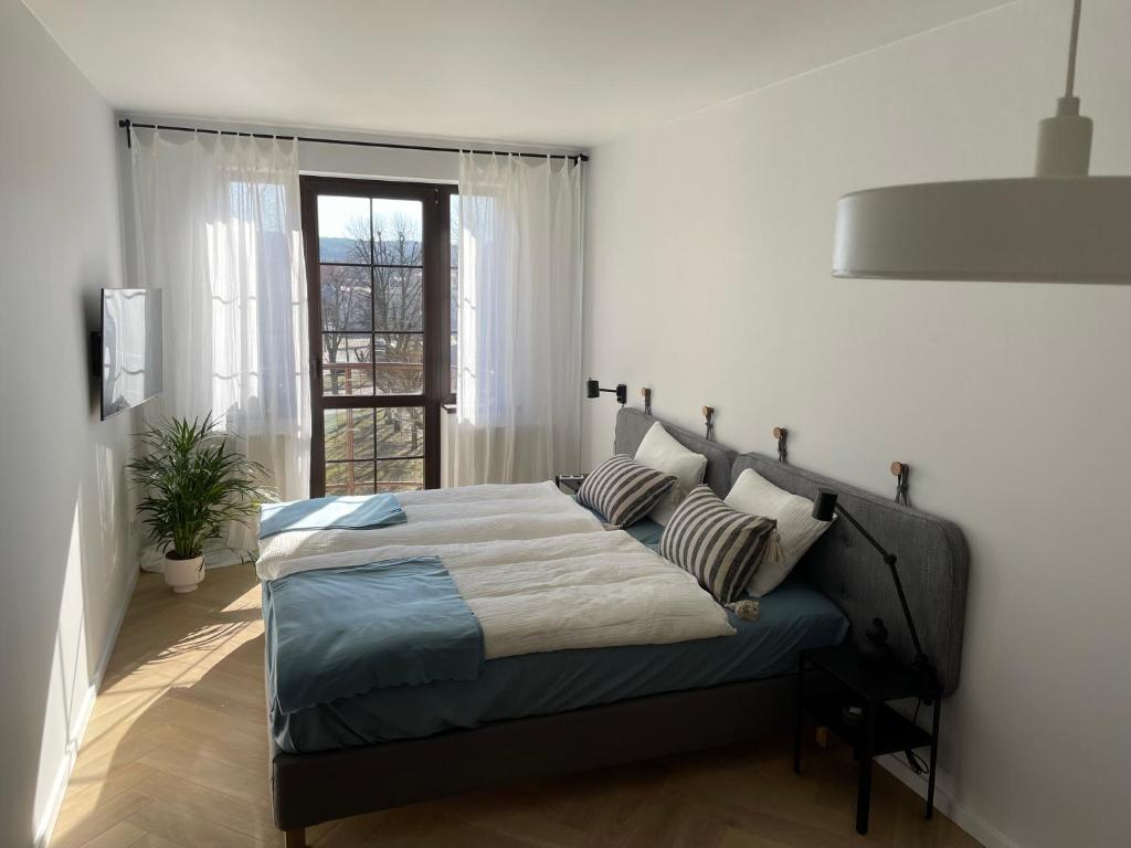 a bedroom with a bed and a window at APARTAMENT OVOC 2.0 in Chodzież