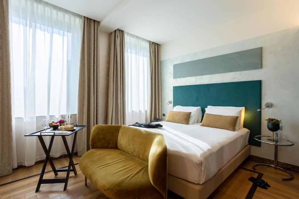 Postel nebo postele na pokoji v ubytování Bianca Maria Palace Hotel