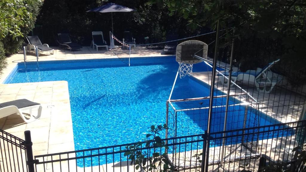 a blue swimming pool with a basketball hoop in it at Grande maison avec piscine in Lorgues