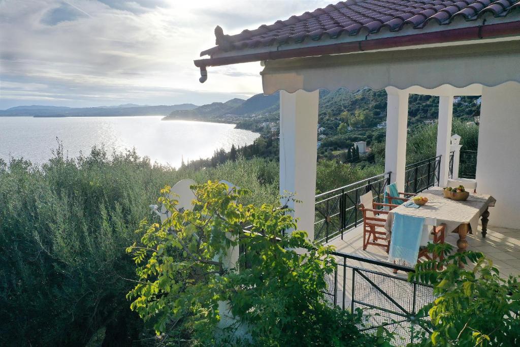 a balcony of a house with a view of the water at Jasmin Villa Nissaki in Nisakion