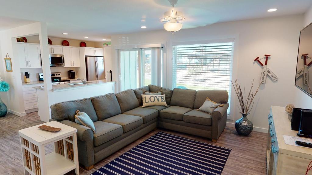 a living room with a couch and a kitchen at AH-B104 Newly Remodeled Ground Floor Condo, Overlooking PoolHot Tub in Port Aransas