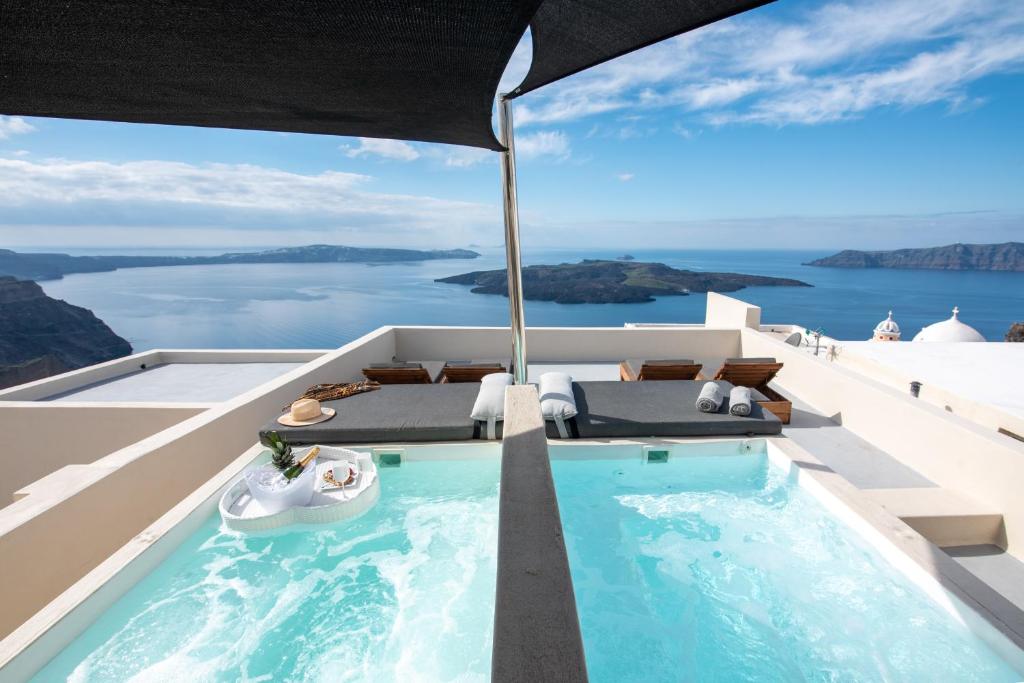 a swimming pool on the roof of a house at Caldera Cliff Illusion in Fira