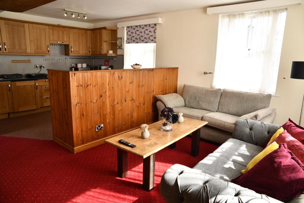 a living room with a couch and a table at The Knighton Apartment in Knighton