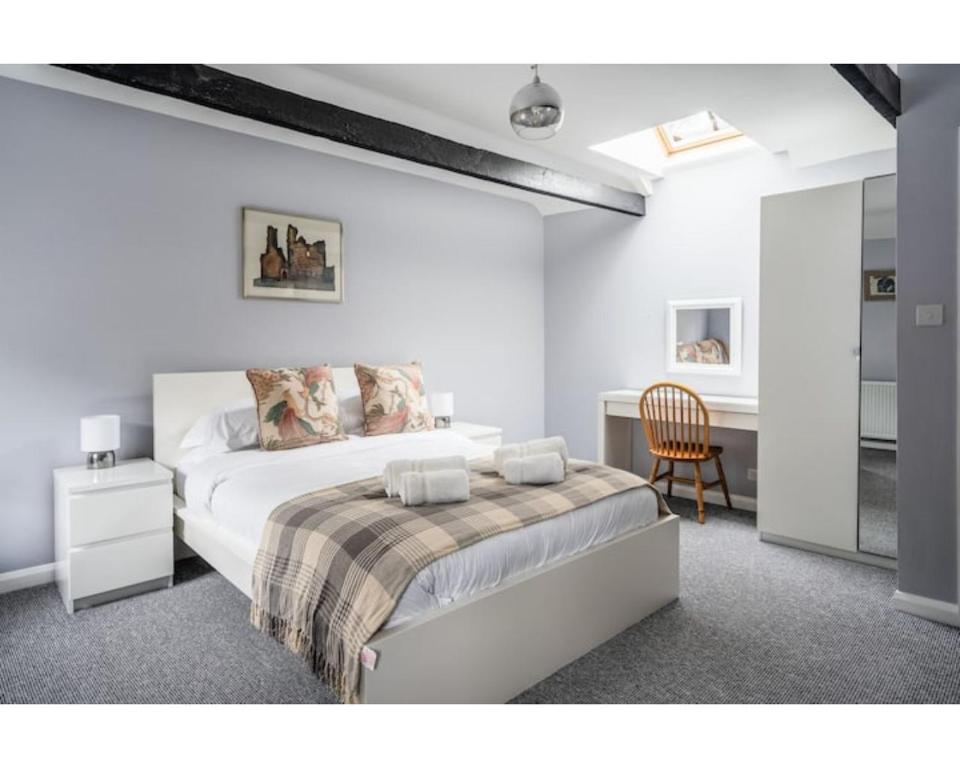 a bedroom with a bed and a desk and a chair at Hatfield Cottage in Bath