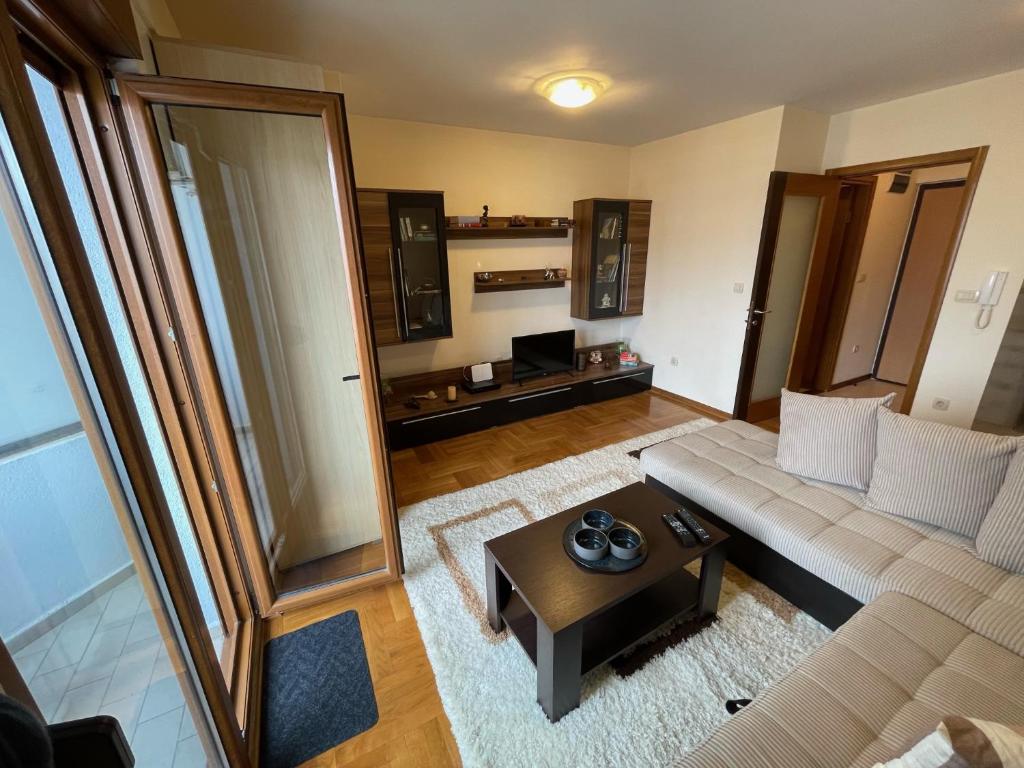 a living room with a couch and a coffee table at Exclusive studio, great location in Podgorica