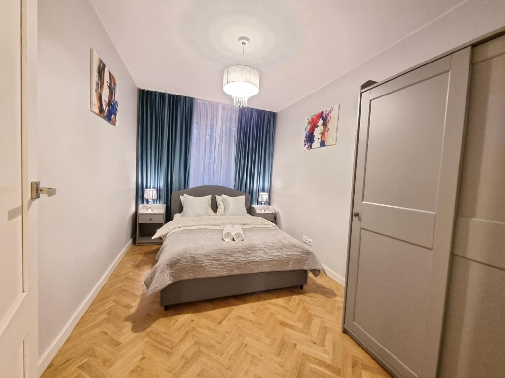 a small bedroom with a bed and a closet at My Beloved Warsaw Żurawia Street in Warsaw