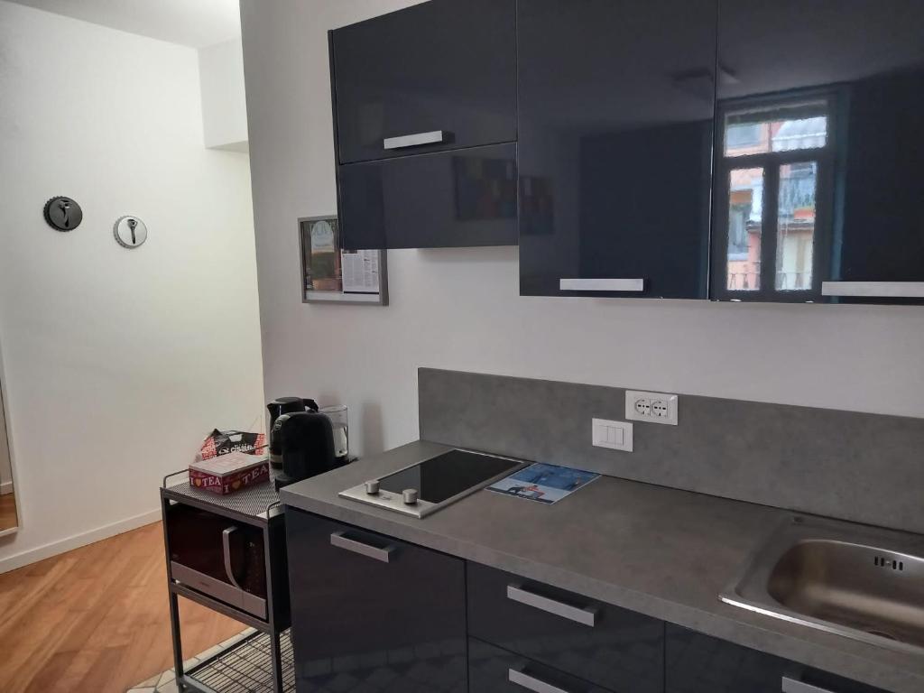 a kitchen with a counter top and a sink at Suite Apartment San Lazzaro in Bergamo