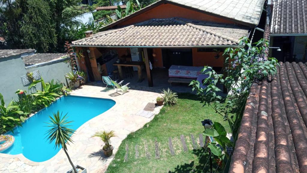 a backyard with a swimming pool and a house at BEM ESTAR À BEIRA MAR in Ubatuba