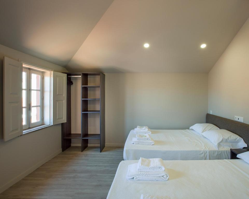 Postel nebo postele na pokoji v ubytování Rua Grande Hotel