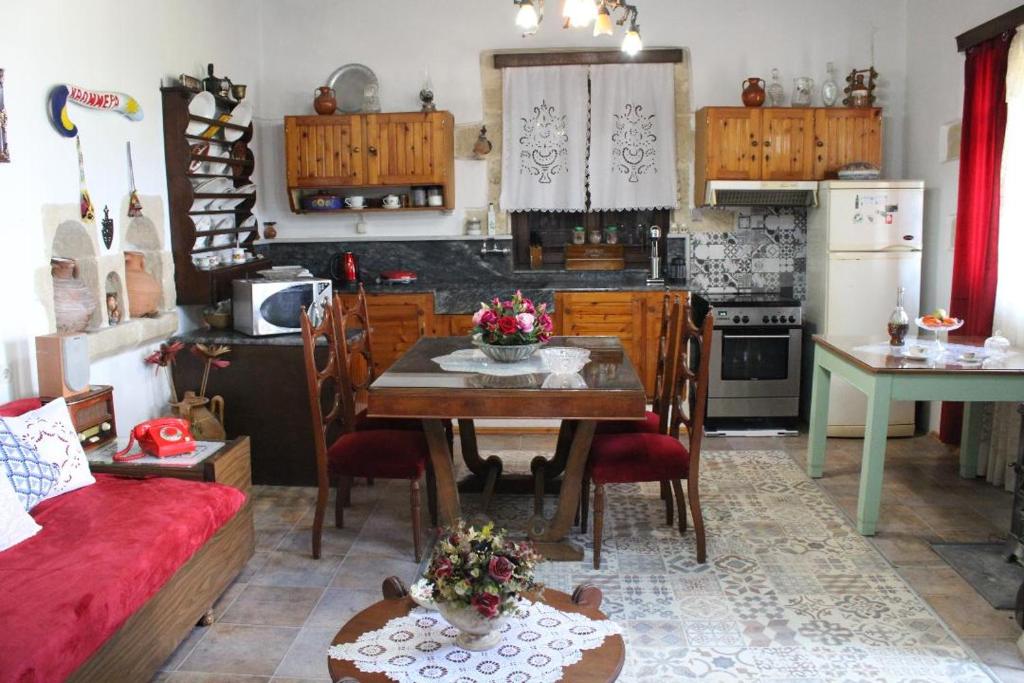 a kitchen with a table and a dining room at TRADITIONAL HOUSE MARIA in Azoyirás